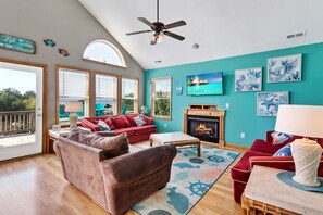 Relax in the spacious Living Area with bright decor and high ceilings.