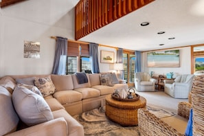 Relax in the beautiful Living Area with high ceilings and welcoming decor.