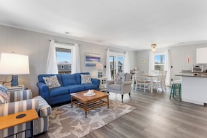 Relax in the bright, spacious Living Area with cozy furniture and a Flat Screen TV!