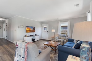 Relax in the bright, spacious Living Area with cozy furniture and a Flat Screen TV!