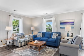 Relax in the bright, spacious Living Area with cozy furniture and a Flat Screen TV!