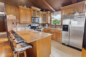 Whip up something delicious in the gorgeous Kitchen with modern appliances and countertop seating.