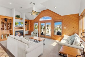 Enjoy perfect serenity with style and comfort in the expansive Top-Level Living Area with high ceilings and a Flat Screen TV.