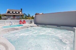 The hot tub located next to the pool is ideal to unwind after a great day filled with fun activities.