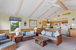 Relax in the tastefully beach-themed Living Area with a Flat Screen TV and plenty of cozy furniture!