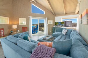 Relax in the spacious Living Area with a Flat Screen TV, beautiful views, and plenty of comfortable furniture.