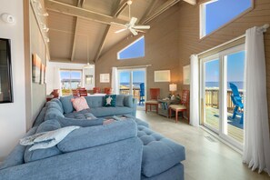 Relax in the spacious Living Area with a Flat Screen TV, beautiful views, and plenty of comfortable furniture.
