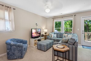 Your family will love gathering in the cozy living area that boasts comfortable furniture and plenty of natural light.