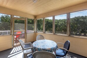 The Screened-In Porch is perfect for al fresco dining protected from the elements.