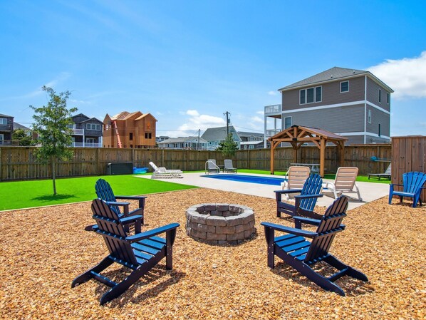 The backyard and pool area have been upgraded for the 2025 season to include a new putting green, new fire pit furniture, & more!