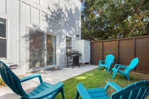 Outdoor area with gas grill and outdoor shower.