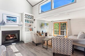 Relax in the spacious Living Area with high ceilings and tastefully modern decor. (Please note: Fireplace is not for guest use.)