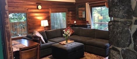 Cozy Living room with vaulted ceilings and windows on 3 walls.
