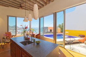 Open living spaces. Kitchen views to pool.