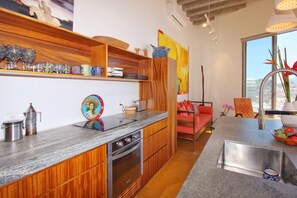 Kitchen with dishwasher and induction stove-top.