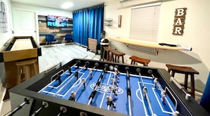 GAME room with  brand new shuffle board, foosball table, 50'' TV and board games