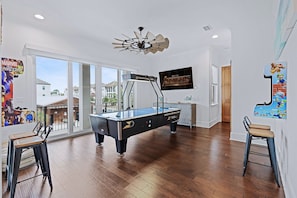 2nd Floor - Game room with commercial grade air hockey table, 2 custom wall-mounted arcades, a 75" 4K smart tv, and access to the wrap around balcony!