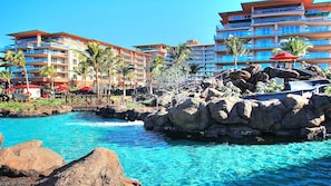 Aquatic park with 9 pools and hot tubs. Family Pool and slide pictured above.