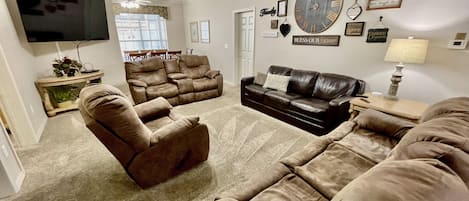 Family room with sleeper sofa and large 65" Smart TV