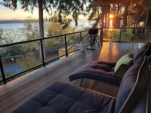 Catch the sunrise while enjoying the panoramic water and mountain views from the adjustable chaise lounges on the covered and heated deck.