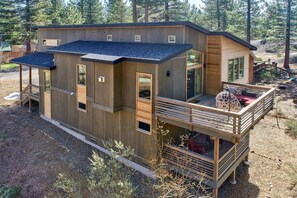 A stylish exterior with a combination of cedar and metal siding welcomes you to this modern mountain home. The upper-level deck doubles as a parking space, blending function and design.