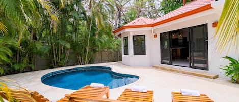 Spacious pool area with lounge chairs.