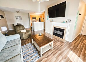 Spacious living room with electric fireplace and Smart TV