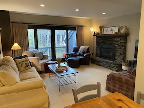 Cozy living room with on demand gas fired fireplace, Roku TV & access to deck.