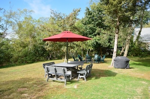 Large yard with fire pit and outdoor dining 