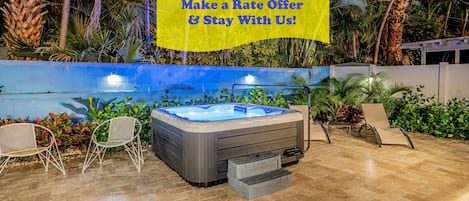 Relax in the private backyard patio with amazing views day & night and amenities that include a soothing hot tub, hammock for two, lounge chairs, BBQ grill and picnic style dining table all surrounded by ocean-themed murals and tropical landscaping.