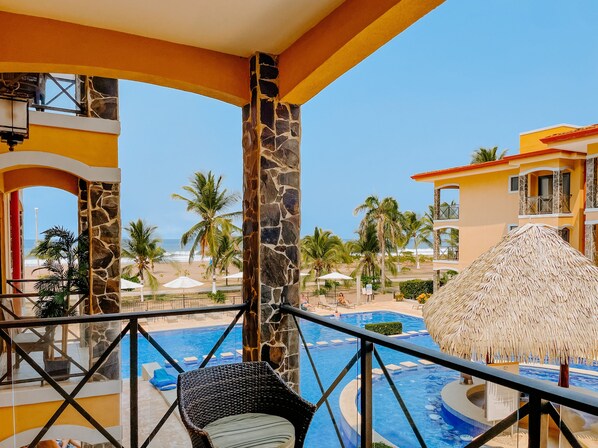 Spacious, modern condo has 4 balconies with seating and ocean and pools views. 
