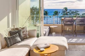 Living room with panoramic ocean & sunset views year round. 75" 4K Sony TV with Sonos sound system, cable and Apple TV. Spacious lanai with a lounge bed for 2 and an elevated dining table and chairs to enjoy the view.