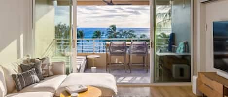 Living room with panoramic ocean & sunset views year round. 75" 4K Sony TV with Sonos sound system, cable and Apple TV. Spacious lanai with a lounge bed for 2 and an elevated dining table and chairs to enjoy the view.