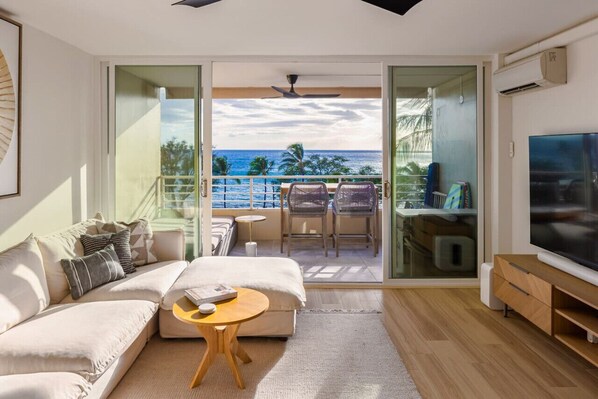Living room with panoramic ocean & sunset views year round. 75" 4K Sony TV with Sonos sound system, cable and Apple TV. Spacious lanai with a lounge bed for 2 and an elevated dining table and chairs to enjoy the view.