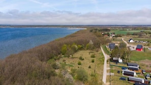 A stunning aerial view of a scenic landscape with hills, trees, and nearby housing.