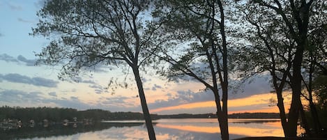 Vibrant sunrises viewed from an expansive lakefront deck.