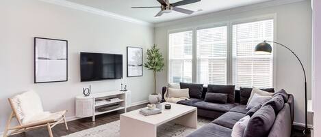 The large, modern living room is perfect for game night or even just watching Netflix on the 55" TV.(Cary, North Carolina executive long-term stay furnished rental)