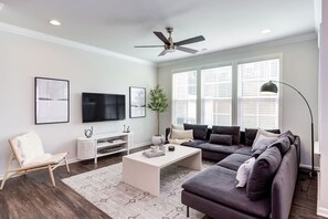 The large, modern living room is perfect for game night or even just watching Netflix on the 55" TV.(Cary, North Carolina executive long-term stay furnished rental)