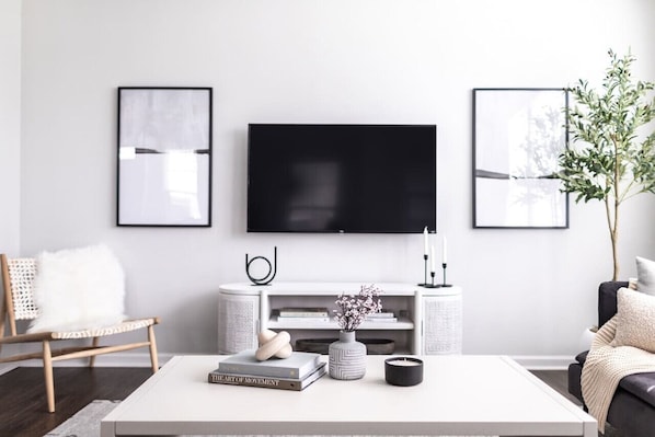 Bright, modern living room with 55" 4K smart TV.(Cary, North Carolina long-term stay furnished rental)(Cary, North Carolina executive furnished rental)