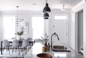 Enjoy the spacious, light-drenched open-concept kitchen and dining area. The dining table seats 8+ and there are also 3 more bar stools. Bon apetit!(Cary, North Carolina executive furnished rental)