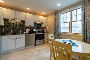 Nicely appointed kitchen with dining table.