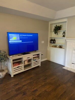 Large Smart TV with remote control in Family room. 