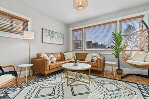 Large windows in front allow natural light to stream in and brighten the living area!