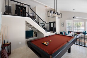 Challenge friends to a game of pool in the lively game room, featuring a high-quality pool table for endless entertainment!