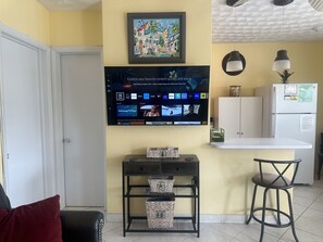 2023 Samsung 50” Smart TV above charging station.