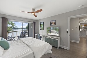 Main Level Primary Suite with sliders to the deck, TV & full bath.