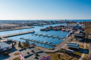  A stunning bird's-eye view of the marina with boats docked and buildings lining the water.