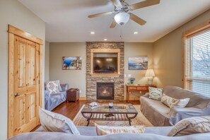 Light, bright living room with flat screen TV and fireplace