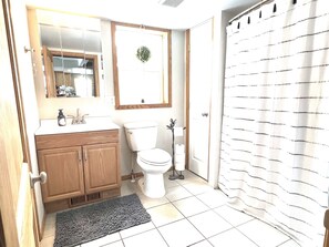 Spacious bathroom with washer and dryer. 