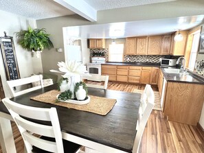 Travel through entryway to kitchen/dinning space.